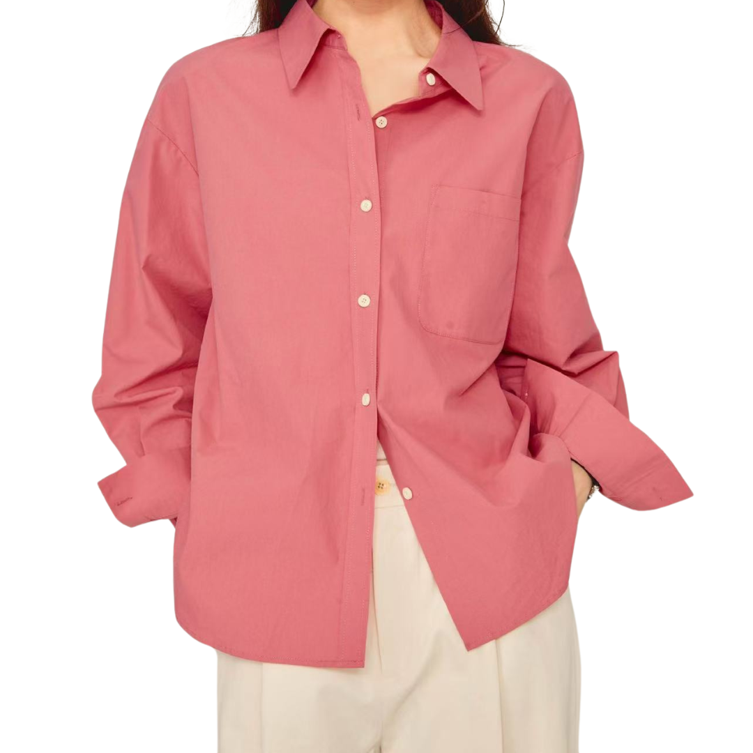 Pink cotton button-front shirt styled open with rolled sleeves